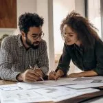 twopeoplelookingatinvestments-min